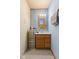 Functional bathroom with a vanity, mirror, and limited storage space at 4976 W Sims Ln, Monrovia, IN 46157