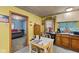 Functional kitchen featuring white appliances, wood cabinetry and a dining table at 4976 W Sims Ln, Monrovia, IN 46157