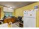 Functional kitchen featuring white appliances, wood cabinetry and an oven at 4976 W Sims Ln, Monrovia, IN 46157