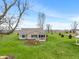 A beautiful backyard with a screened porch, landscaped flowerbeds, and a lush lawn at 52 E 286Th St, Atlanta, IN 46031