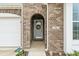 Charming entryway with a brick archway, featuring a decorative wreath and the house number at 52 E 286Th St, Atlanta, IN 46031
