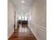 Hallway featuring hardwood floors, wainscoting, and a view into the living room at 52 E 286Th St, Atlanta, IN 46031