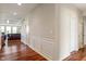 Hallway featuring hardwood floors, wainscoting, and a view into the living room at 52 E 286Th St, Atlanta, IN 46031