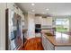 Well-equipped kitchen with stainless steel appliances, granite countertops, white cabinets, and wood flooring at 52 E 286Th St, Atlanta, IN 46031