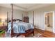 Comfortable bedroom with four-poster bed, wood floors, and serene ambiance with natural light at 52 E 286Th St, Atlanta, IN 46031