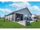The backyard has a patio with an outdoor kitchen, green grass, landscaping, and a fence at 5218 Pinehurst Ct, Whitestown, IN 46075