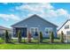 View of the home's backyard with green grass, landscaping, outdoor kitchen and fence at 5218 Pinehurst Ct, Whitestown, IN 46075