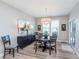 Well-lit dining room features stylish chandelier, sideboard, and sliding glass door at 5218 Pinehurst Ct, Whitestown, IN 46075