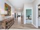 Bright hallway with wood-look floors leading to living spaces, showcasing modern design at 5218 Pinehurst Ct, Whitestown, IN 46075