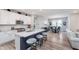 Open-concept kitchen with breakfast bar, stainless appliances, and adjacent dining area at 5218 Pinehurst Ct, Whitestown, IN 46075