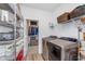 Laundry room with modern washer and dryer, shelving, and storage space adjacent to a walk-in closet at 5218 Pinehurst Ct, Whitestown, IN 46075