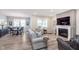 Open-concept living room with fireplace flows into dining area with stylish decor at 5218 Pinehurst Ct, Whitestown, IN 46075