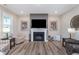 Cozy living room featuring a fireplace with a decorative mantel and natural light at 5218 Pinehurst Ct, Whitestown, IN 46075