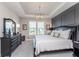 The main bedroom includes tray ceilings, neutral walls, and dark wood furniture at 5218 Pinehurst Ct, Whitestown, IN 46075