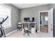 Well-lit office with a neutral color palette, an adjustable desk, and a view into the home at 5218 Pinehurst Ct, Whitestown, IN 46075