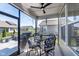 Cozy screened porch with a ceiling fan, a table with four chairs, and outdoor views at 5218 Pinehurst Ct, Whitestown, IN 46075