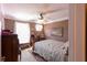Bright bedroom with a ceiling fan, natural light, and charming decorations on the wall at 5251 Ladywood Bluff Pl, Indianapolis, IN 46226