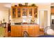 Dining area with wood cabinets, a breakfast bar, and stylish decorations at 5251 Ladywood Bluff Pl, Indianapolis, IN 46226