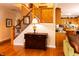 Welcoming entryway featuring wood floors, a staircase with wood railing, and a view into the kitchen at 5251 Ladywood Bluff Pl, Indianapolis, IN 46226