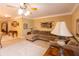 Comfortable living room with a large sectional couch, ceiling fan, and a cozy lamp at 5251 Ladywood Bluff Pl, Indianapolis, IN 46226