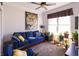Bright living room featuring hardwood floors, natural light, and a comfortable blue couch with colorful throw pillows at 5251 Ladywood Bluff Pl, Indianapolis, IN 46226