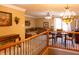 Open-concept living space with a large sectional couch and a dining table beneath a decorative chandelier at 5251 Ladywood Bluff Pl, Indianapolis, IN 46226