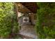 Inviting outdoor patio with a stone fireplace and stylish paving, surrounded by lush greenery and mature landscaping at 5251 Ladywood Bluff Pl, Indianapolis, IN 46226
