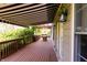 Covered wooden deck featuring an awning and lush greenery, great for outdoor enjoyment at 5251 Ladywood Bluff Pl, Indianapolis, IN 46226