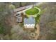 Aerial view of a two-story home with a pool, shed, and fire pit in a wooded area at 5307 S State Road 135, Morgantown, IN 46160