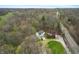 Aerial view of a home and pool surrounded by lush green trees, and a winding paved road at 5307 S State Road 135, Morgantown, IN 46160