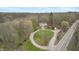 Aerial view of a house with a circular driveway, shed, pool, and roadside access at 5307 S State Road 135, Morgantown, IN 46160