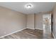 Bedroom featuring neutral paint, wood-look floors, an overhead light, and a door to the next room at 5307 S State Road 135, Morgantown, IN 46160