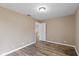 Bright bedroom featuring neutral paint, wood-look floors, and a doorway to the next room at 5307 S State Road 135, Morgantown, IN 46160