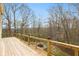 Wooden deck with wooden railing overlooking the tree-lined backyard at 5307 S State Road 135, Morgantown, IN 46160