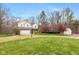 Expansive lawn surrounds the two-story home, complemented by a basketball hoop and storage shed at 5307 S State Road 135, Morgantown, IN 46160