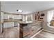 Modern kitchen featuring white cabinets, stainless steel appliances, and a breakfast bar with wooden accents at 5307 S State Road 135, Morgantown, IN 46160