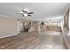 Open-concept living area with wood-look floors, connecting to a staircase and kitchen at 5307 S State Road 135, Morgantown, IN 46160