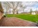 Large backyard with deck, mature trees, and a shed at 5576 N Heritage Ln, Alexandria, IN 46001