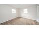 This bedroom has neutral carpet, white walls, and natural light from two windows at 5576 N Heritage Ln, Alexandria, IN 46001