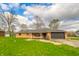 Cozy single-story brick home features a two-car garage and well-maintained lawn at 5576 N Heritage Ln, Alexandria, IN 46001