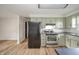 View of the kitchen offering stainless steel appliances, and black countertops at 5576 N Heritage Ln, Alexandria, IN 46001