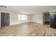 Bright living room with new flooring and view of the front entry and kitchen at 5576 N Heritage Ln, Alexandria, IN 46001