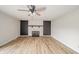 Cozy living room with fireplace, ceiling fan, and attractive wood flooring at 5576 N Heritage Ln, Alexandria, IN 46001