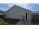 Back of house showing sliding glass door, vinyl siding, small window, and concrete patio at 5609 Sweet River Dr, Indianapolis, IN 46221
