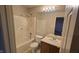 A cozy bathroom includes a bathtub/shower combination, toilet, vanity with a mirror, and linoleum flooring at 5609 Sweet River Dr, Indianapolis, IN 46221