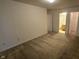 A bedroom showing neutral walls, carpet flooring, and a doorway leading to the bathroom at 5609 Sweet River Dr, Indianapolis, IN 46221