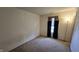 A simple bedroom with neutral walls, carpet flooring, a window with curtains, and a floor lamp at 5609 Sweet River Dr, Indianapolis, IN 46221