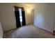 Bedroom features neutral walls, carpet flooring, a window with curtains, and a doorway at 5609 Sweet River Dr, Indianapolis, IN 46221