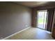 Bright dining room with a sliding door, neutral walls, tile floor, and natural light at 5609 Sweet River Dr, Indianapolis, IN 46221