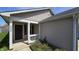A cozy front porch with white pillars leading to the home's front door and a small window at 5609 Sweet River Dr, Indianapolis, IN 46221